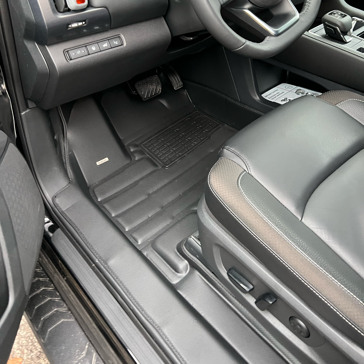 Mat Up! custom-fit all-weather floor mats installed in a vehicle footwell