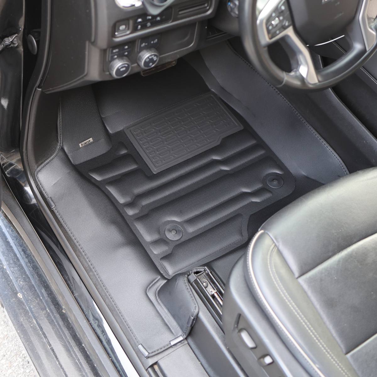 GMC Sierra, the mats covering the floor, along with the plastic doorsets