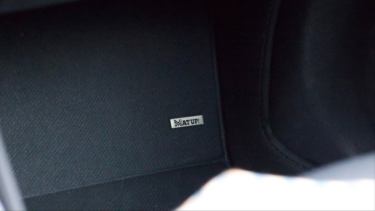 Close-up of the driver mat: the textured heel pad under the accelerator and the ribbed surface around it