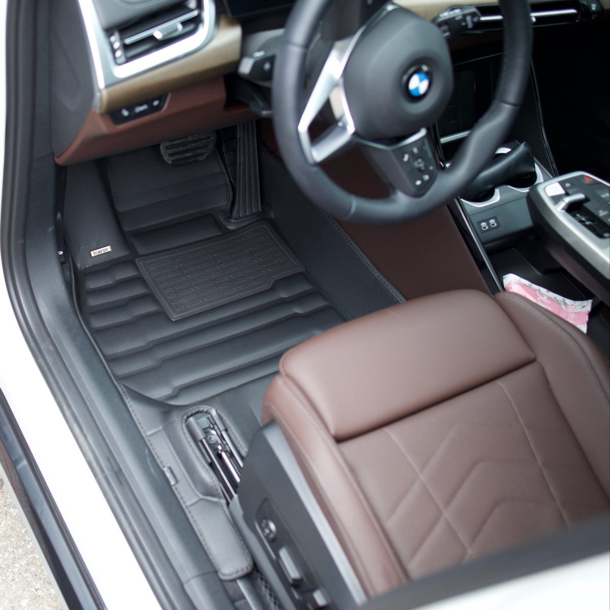 Lexus GX driver footwell with sport pedals and a black mat covering the floor to the edges